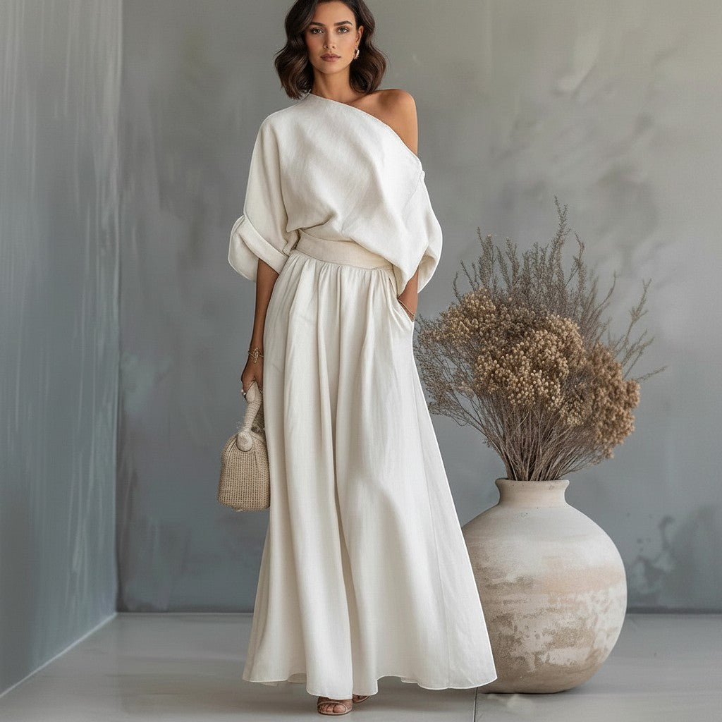 Modelo vistiendo conjunto blanco de dos piezas vestismuse con top de hombro descubierto y pantalón largo fluido