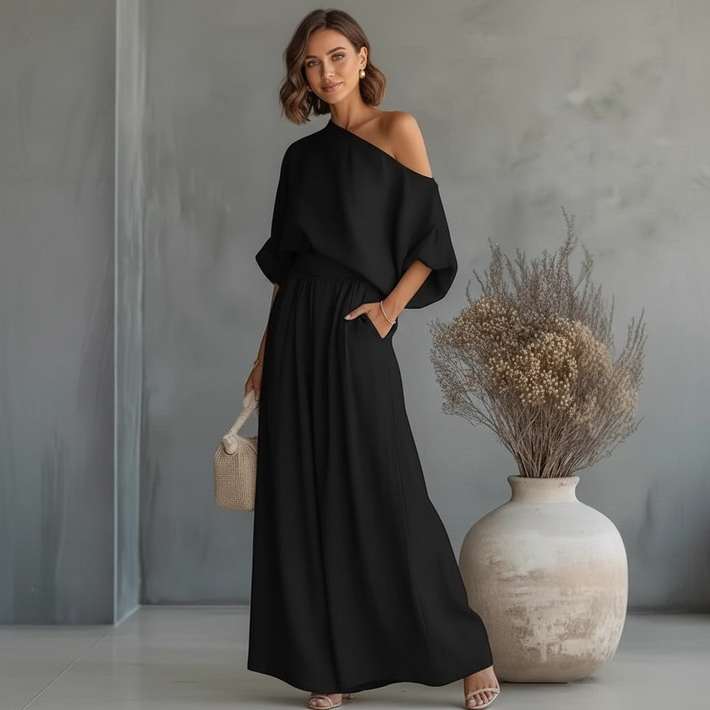 Mujer vistiendo conjunto negro vestismuse de top hombro descubierto y pantalón amplio de poliéster con caída fluida